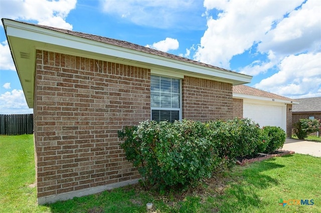 3903 Kevin Shaw Dr, Killeen, TX 76549 - view of side of property featuring brick siding, an attached garage, and concrete driveway