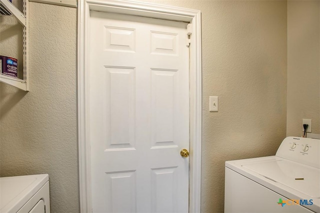 3903 Kevin Shaw Dr, Killeen, TX 76549 - washroom featuring washing machine and clothes dryer and a textured wall