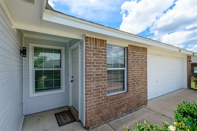 3903 Kevin Shaw Dr, Killeen, TX 76549 - doorway to property featuring brick siding, driveway, and an attached garage