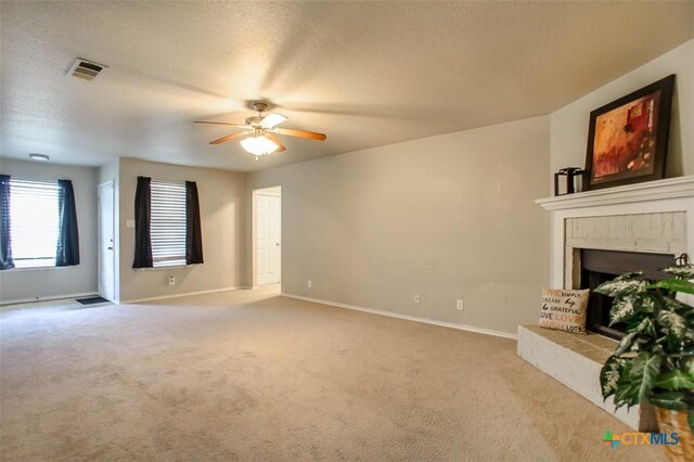 3903 Kevin Shaw Dr, Killeen, TX 76549 - unfurnished living room with a ceiling fan, a brick fireplace, carpet, and a textured ceiling