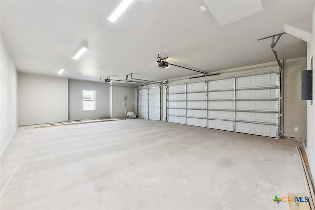 garage featuring electric panel and a garage door opener