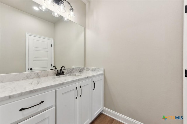 bathroom with vanity and hardwood / wood-style flooring