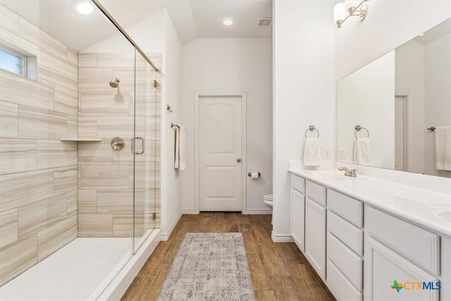 2619 Settlers Oak Dr, Belton, TX 76513 - bathroom with double vanity, toilet, wood finished floors, a sink, and a stall shower