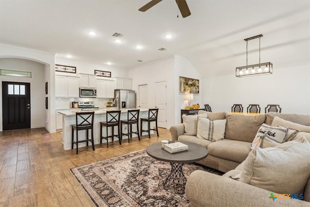 2619 Settlers Oak Dr, Belton, TX 76513 - living area with light wood finished floors, visible vents, arched walkways, ceiling fan, and ornamental molding