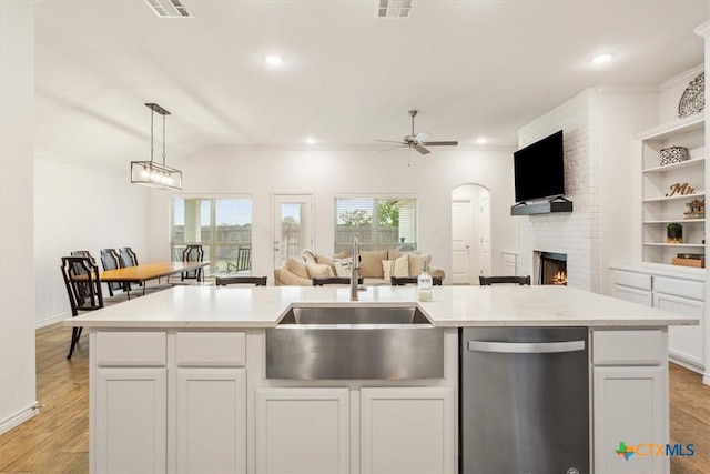 2619 Settlers Oak Dr, Belton, TX 76513 - kitchen featuring a fireplace, a sink, stainless steel dishwasher, and open floor plan