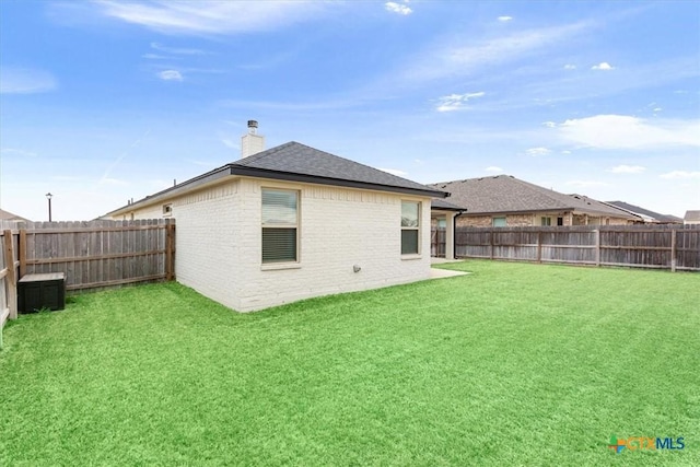 2619 Settlers Oak Dr, Belton, TX 76513 - back of house featuring a fenced backyard, a lawn, a chimney, and brick siding