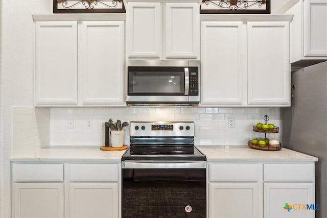 2619 Settlers Oak Dr, Belton, TX 76513 - kitchen featuring white cabinets, decorative backsplash, and appliances with stainless steel finishes