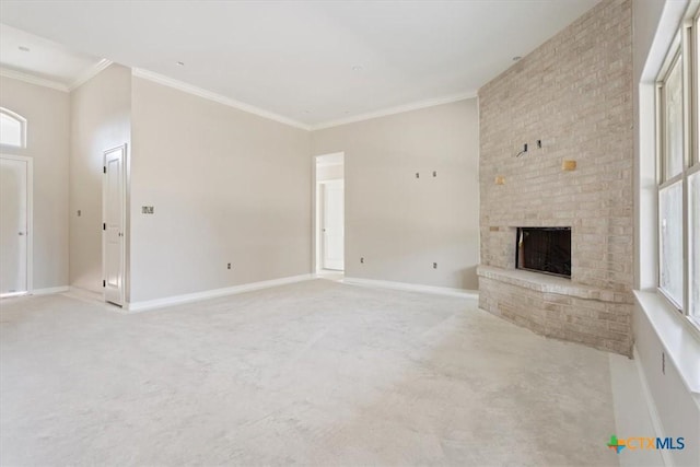 unfurnished living room with light carpet, baseboards, a fireplace, and ornamental molding
