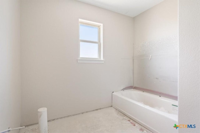 full bath featuring a tub to relax in