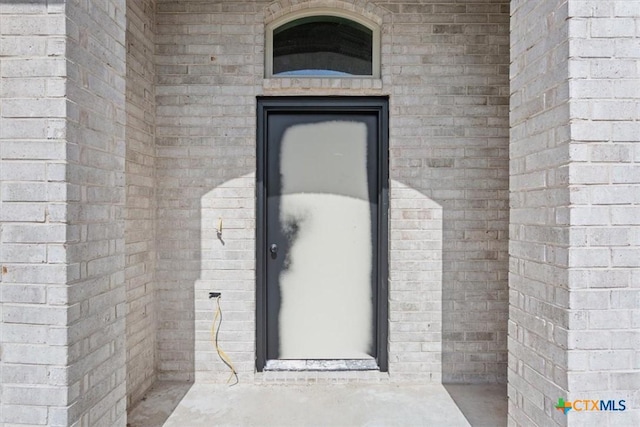 property entrance with brick siding