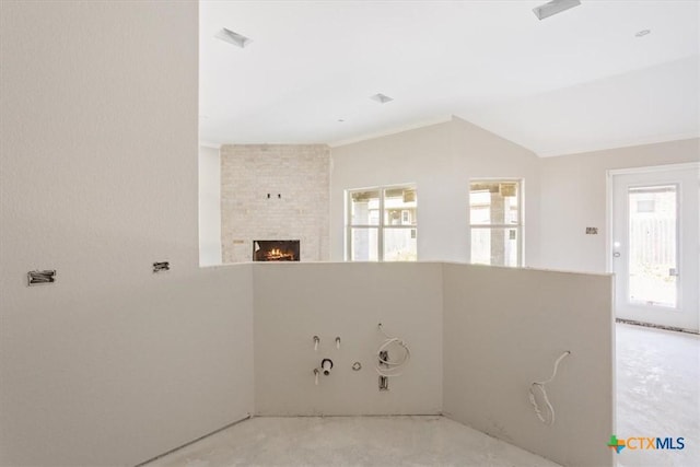 empty room with a healthy amount of sunlight and a brick fireplace