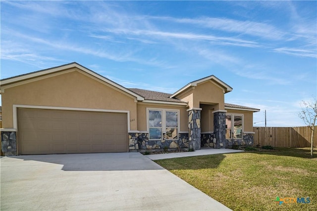 view of front of house with a front yard and a garage