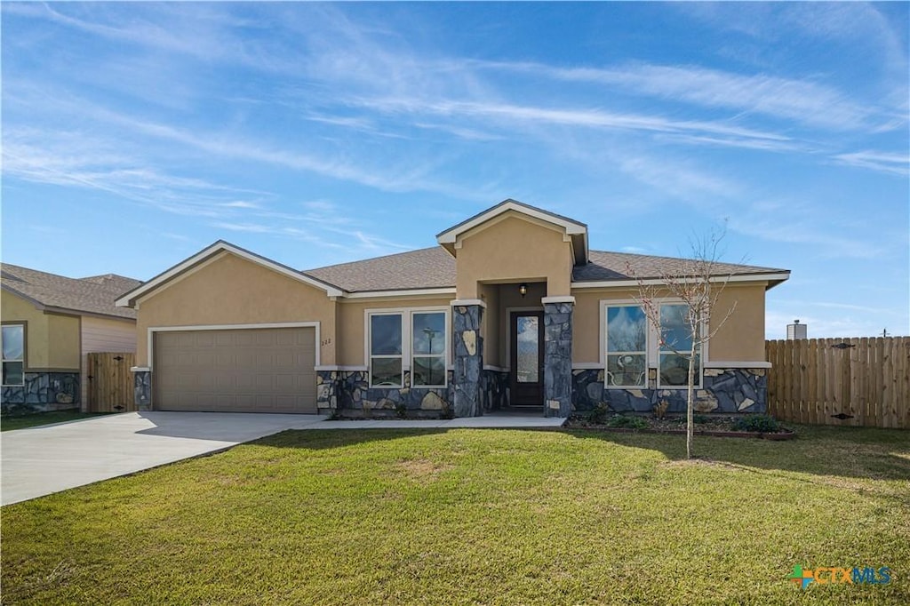 view of front of house with a front lawn and a garage