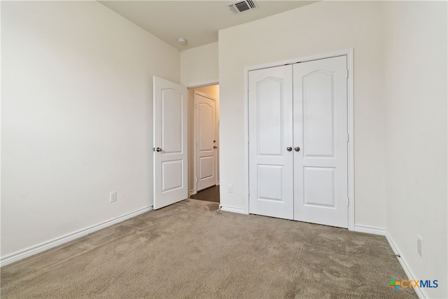 unfurnished bedroom featuring a closet and carpet