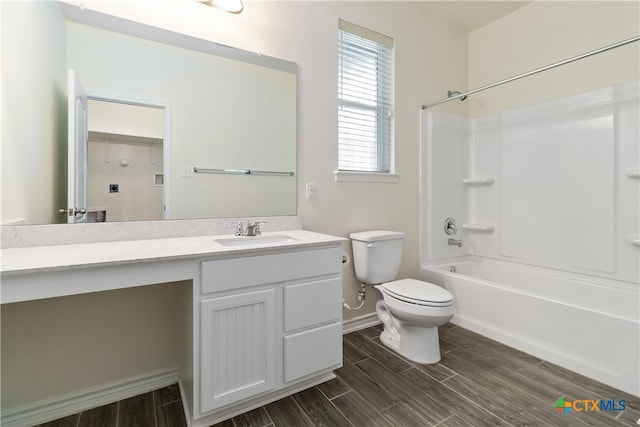 full bathroom with toilet, vanity, hardwood / wood-style flooring, and washtub / shower combination