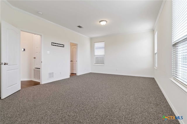 empty room with crown molding and dark carpet