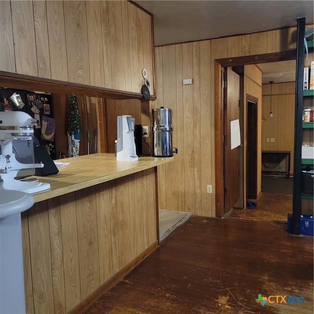 706 S 1st St, Copperas Cove, TX 76522 - kitchen featuring hardwood / wood-style floors, wood walls, and light brown cabinets