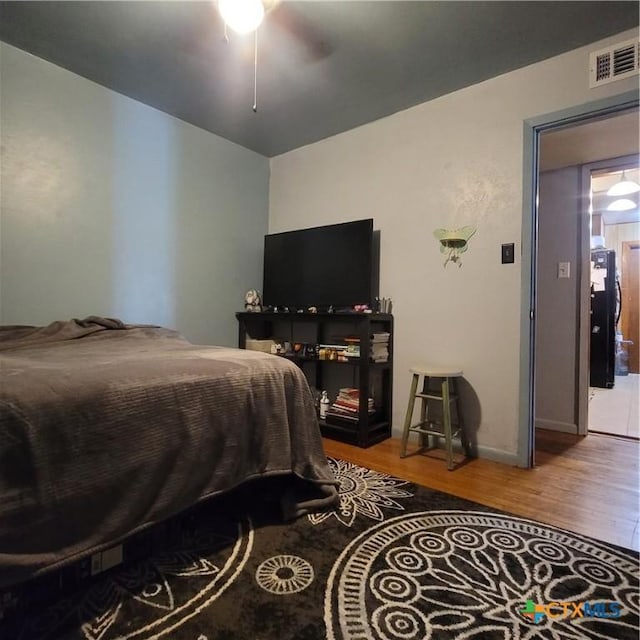 706 S 1st St, Copperas Cove, TX 76522 - bedroom with wood finished floors, baseboards, and ceiling fan