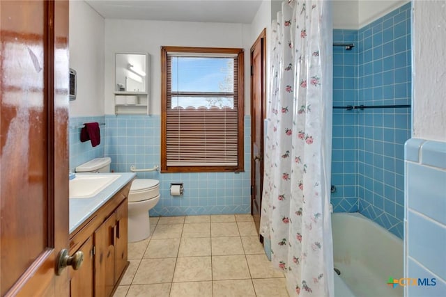 bathroom with tile patterned flooring, vanity, tile walls, and toilet