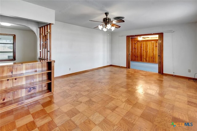 unfurnished room with ceiling fan and light parquet flooring