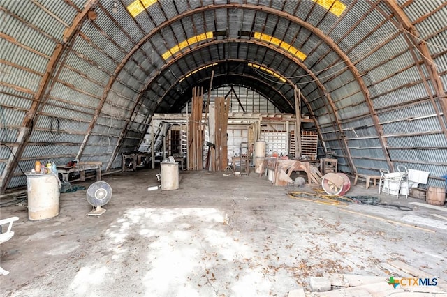 miscellaneous room featuring concrete flooring and vaulted ceiling