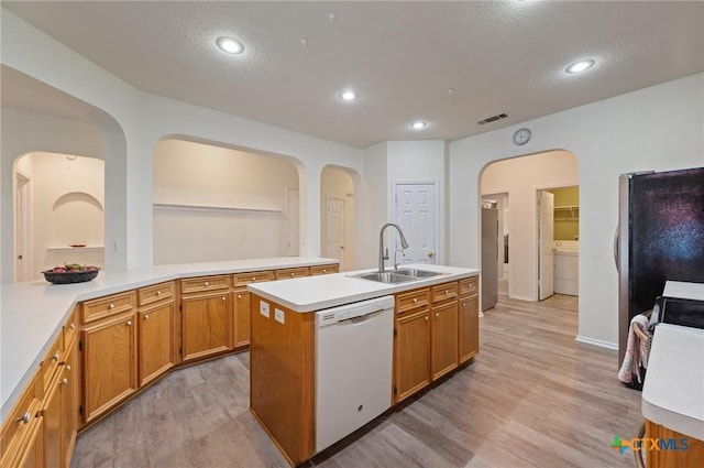 104 Missouri Dr, Harker Heights, TX 76548 - kitchen with dishwasher, a sink, arched walkways, light wood-style flooring, and freestanding refrigerator