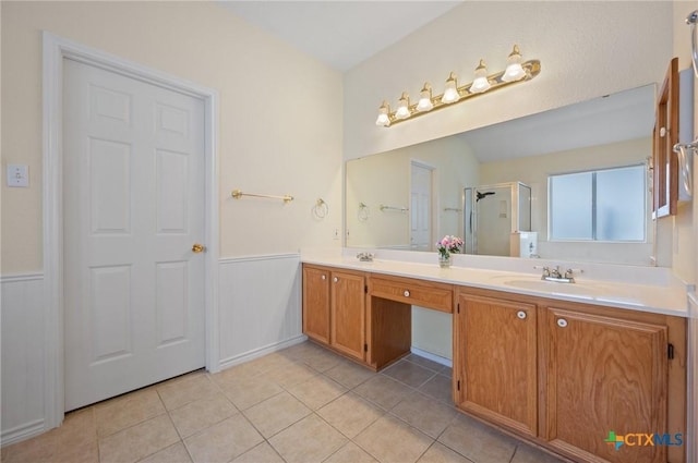 104 Missouri Dr, Harker Heights, TX 76548 - full bathroom with double vanity, a wainscoted wall, a shower stall, and tile patterned floors