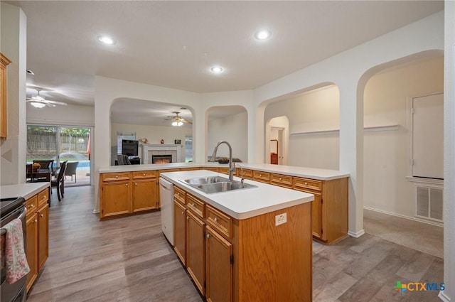 104 Missouri Dr, Harker Heights, TX 76548 - kitchen with a sink, ceiling fan, an island with sink, light wood-type flooring, and a tile fireplace