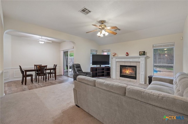 104 Missouri Dr, Harker Heights, TX 76548 - carpeted living room featuring a ceiling fan, arched walkways, and a fireplace