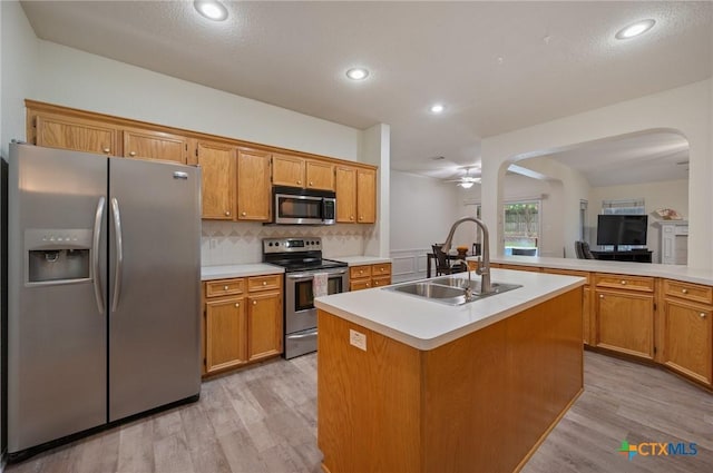 104 Missouri Dr, Harker Heights, TX 76548 - kitchen with appliances with stainless steel finishes, a sink, light wood-style flooring, arched walkways, and recessed lighting