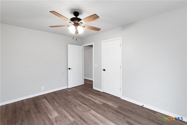 unfurnished bedroom featuring dark hardwood / wood-style flooring and ceiling fan