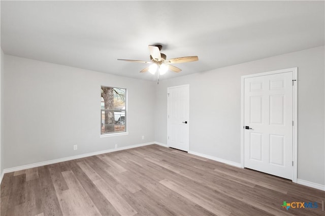 empty room featuring ceiling fan and light wood-type flooring