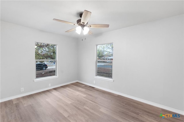 unfurnished room featuring light hardwood / wood-style flooring, plenty of natural light, and ceiling fan