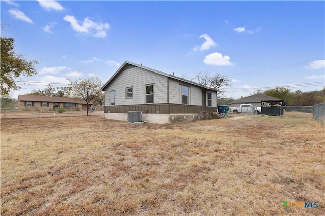 view of side of home featuring central AC unit