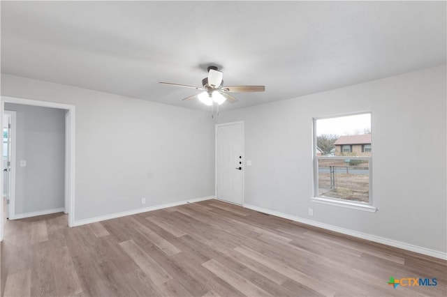 spare room with light wood-type flooring and ceiling fan