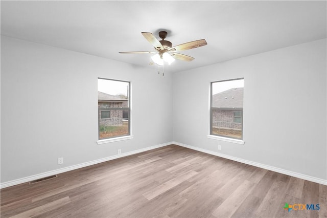 spare room featuring light hardwood / wood-style flooring and ceiling fan