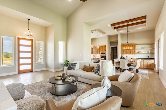 104 Hondo Vis, La Vernia, TX 78121 - living room with a chandelier, light wood-style floors, and a high ceiling