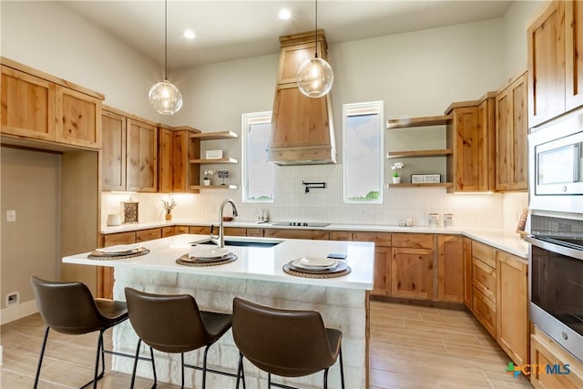104 Hondo Vis, La Vernia, TX 78121 - kitchen with open shelves, oven, black electric cooktop, backsplash, and light countertops