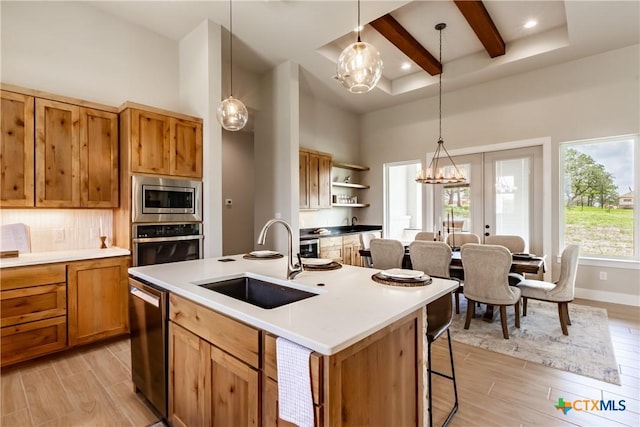 104 Hondo Vis, La Vernia, TX 78121 - kitchen featuring stainless steel appliances, light wood-type flooring, a high ceiling, beam ceiling, and open shelves