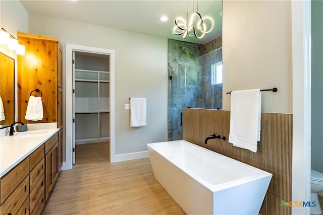 104 Hondo Vis, La Vernia, TX 78121 - full bath featuring a freestanding tub, vanity, a tile shower, a chandelier, and wood finished floors