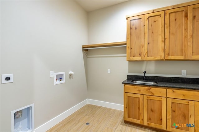 104 Hondo Vis, La Vernia, TX 78121 - washroom featuring hookup for an electric dryer, washer hookup, cabinet space, light wood-type flooring, and bar with sink