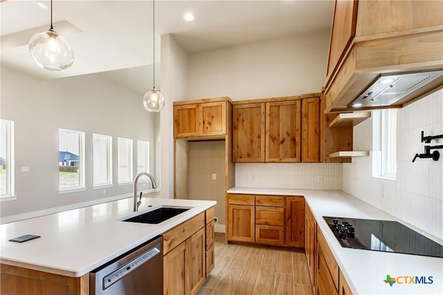 kitchen with dishwasher, black electric stovetop, sink, decorative backsplash, and decorative light fixtures