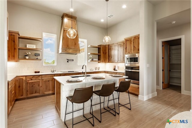 104 Hondo Vis, La Vernia, TX 78121 - kitchen with open shelves, appliances with stainless steel finishes, light wood-style floors, light countertops, and recessed lighting