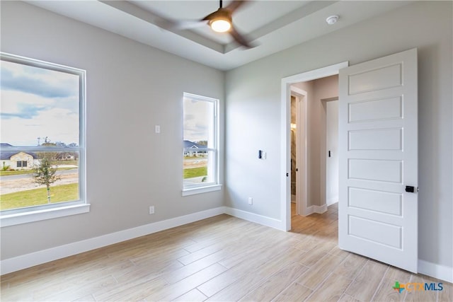 unfurnished room with ceiling fan and light wood-type flooring