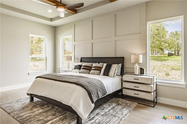 104 Hondo Vis, La Vernia, TX 78121 - bedroom with multiple windows, light wood-style floors, and recessed lighting