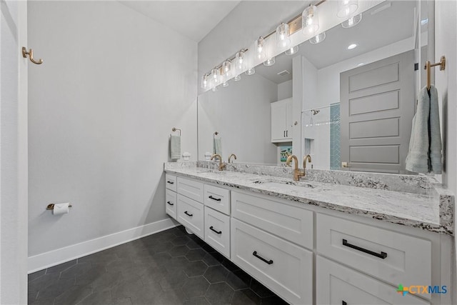 bathroom with tile patterned floors and vanity