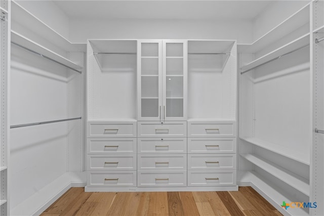 spacious closet featuring light hardwood / wood-style floors