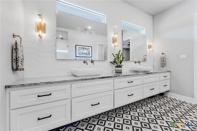 bathroom featuring vanity and tasteful backsplash