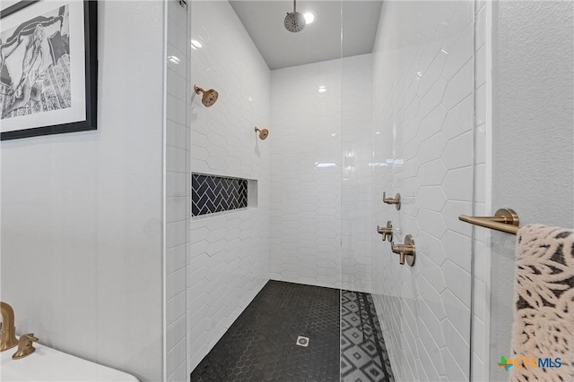 bathroom with a tile shower