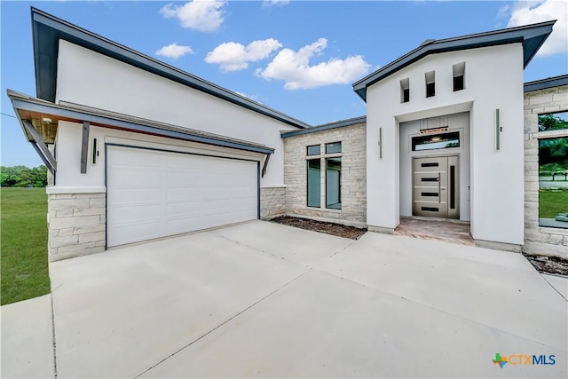 6846 Spring Branch Rd, Spring Branch, TX 78070 - modern home with stone siding, stucco siding, and driveway